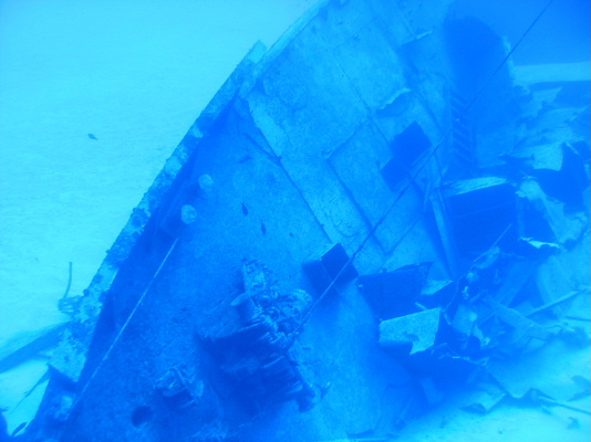 Diver hovering on bow of 7-Screws Shipwreck
